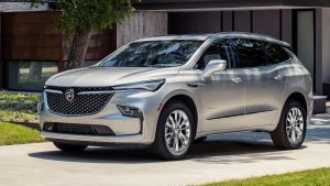 A silver, 2022 Buick Enclave parked in front of a driveway.