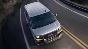 Grey 2021 Savana driving down the highway.